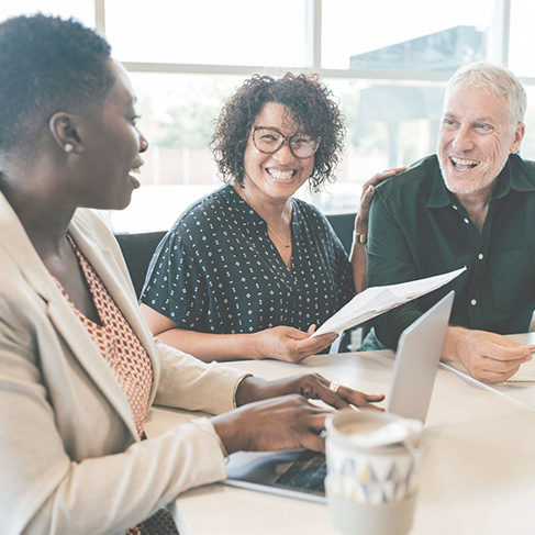 Photo of three people at a desk