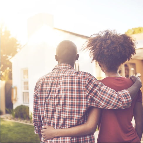 Photo of a couple looking at a house